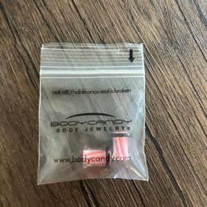 Body Candy 0G Pink & white Ear Plugs with black rings. Perfect for a bold look.